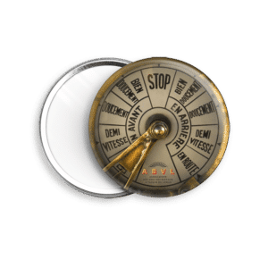 Close-up of a brass circular gauge with a pointer, segmented dial labeled STOP and French terms, ABVL logo at the bottom.